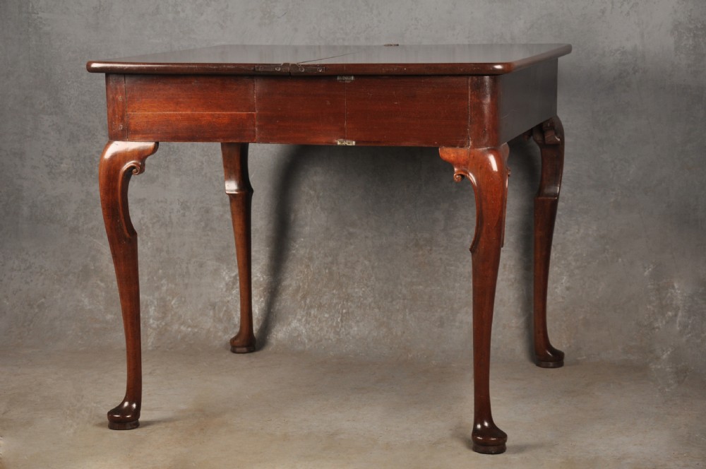 An 18th-century mahogany tea table featuring a folding rectangular top, concertina frame action, and cabriole legs with pad feet. View VI