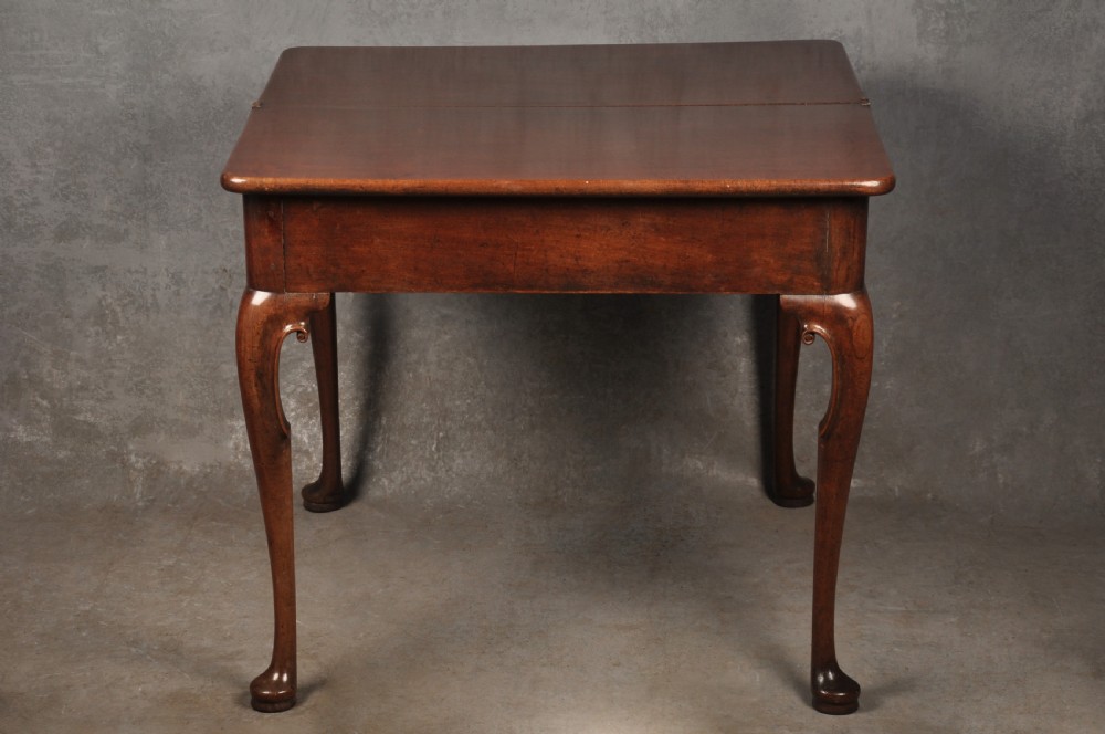 An 18th-century mahogany tea table featuring a folding rectangular top, concertina frame action, and cabriole legs with pad feet. View VII