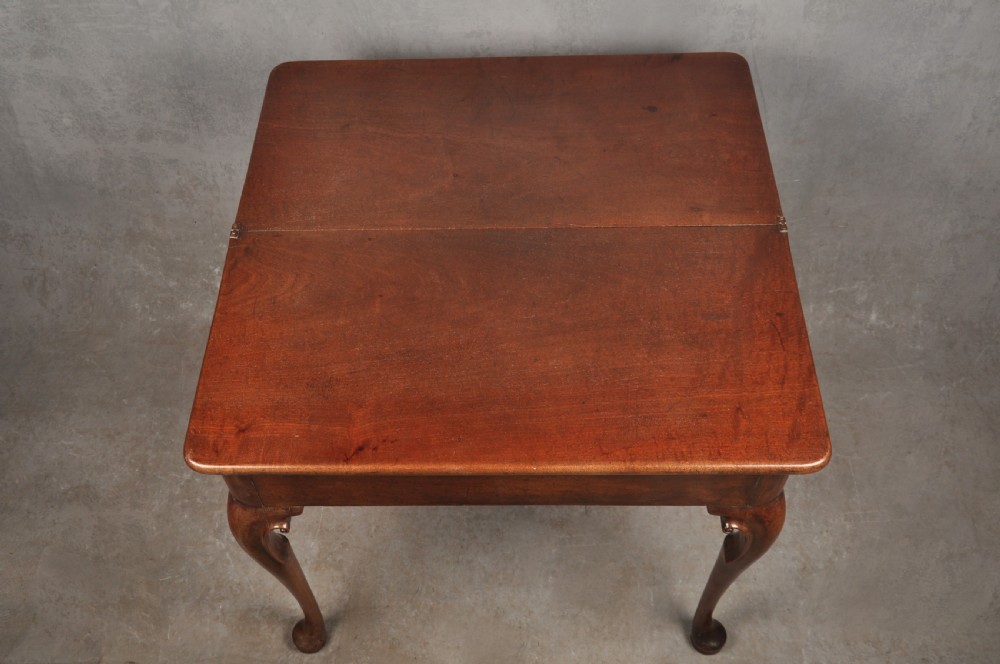 An 18th-century mahogany tea table featuring a folding rectangular top, concertina frame action, and cabriole legs with pad feet. View IX