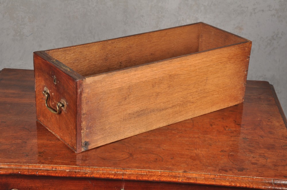 A mid-18th-century mahogany kneehole desk featuring a long upper drawer, six small side drawers, brass handles, and a central recessed cupboard on bracket feet. View VI