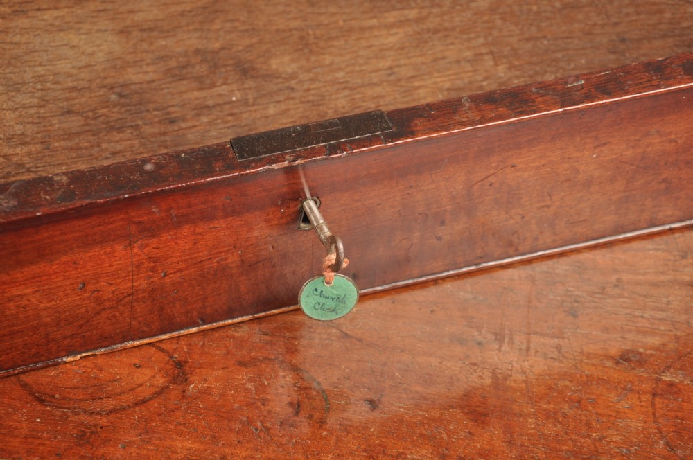 A mid-18th-century mahogany kneehole desk featuring a long upper drawer, six small side drawers, brass handles, and a central recessed cupboard on bracket feet. View VII