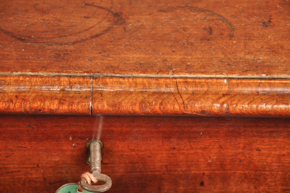 A mid-18th-century mahogany kneehole desk featuring a long upper drawer, six small side drawers, brass handles, and a central recessed cupboard on bracket feet. View VIII