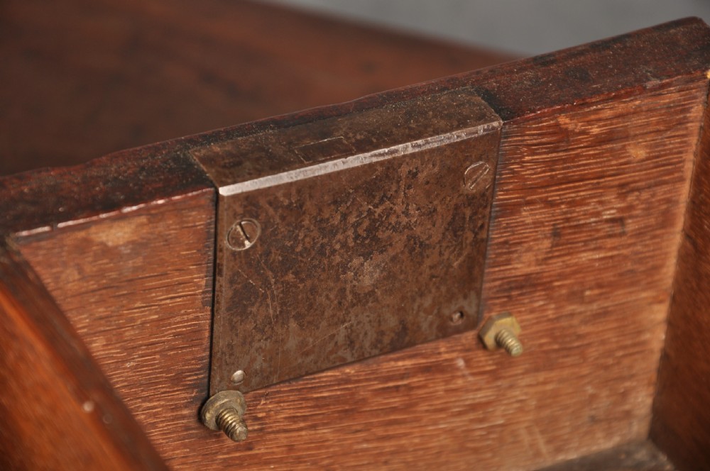A mid-18th-century mahogany kneehole desk featuring a long upper drawer, six small side drawers, brass handles, and a central recessed cupboard on bracket feet. View IX