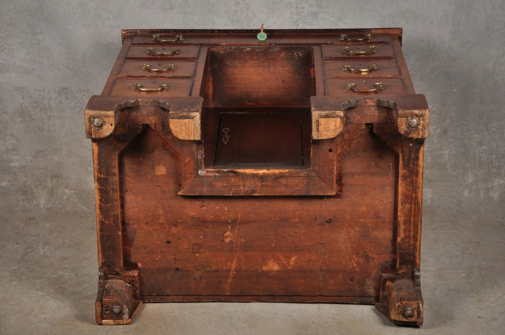 A mid-18th-century mahogany kneehole desk featuring a long upper drawer, six small side drawers, brass handles, and a central recessed cupboard on bracket feet. View XI