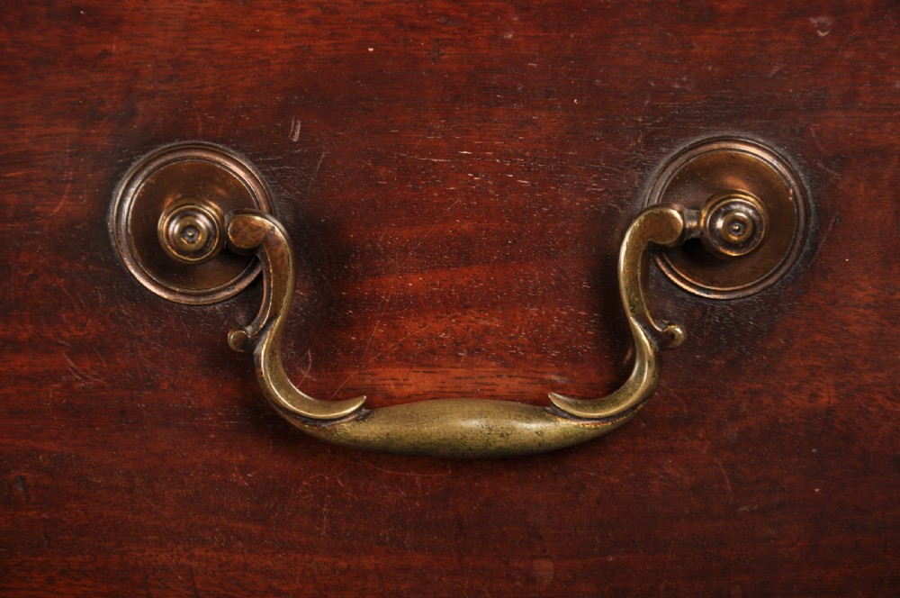 An 18th-century Georgian mahogany tallboy chest-on-chest featuring two stacked sections with brass swan-neck handles, dentil moulding, fluted canted corners, and bracket feet. View IV