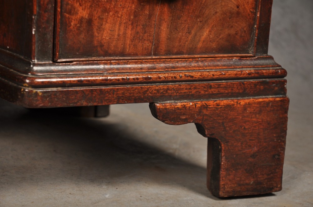 An 18th-century Georgian mahogany kneehole desk featuring brass swan-neck handles, a central recessed cupboard, and bracket feet. View VII