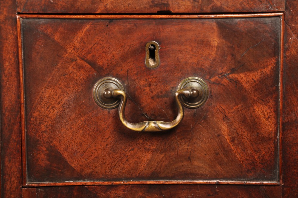 An 18th-century Georgian mahogany kneehole desk featuring brass swan-neck handles, a central recessed cupboard, and bracket feet. View VIII