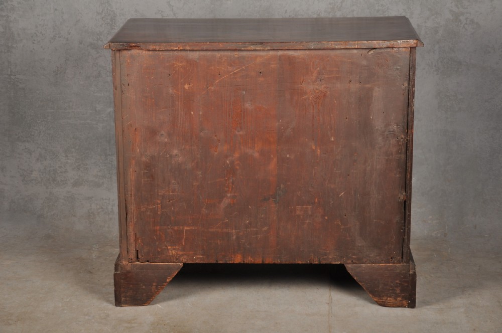 An 18th-century Georgian mahogany kneehole desk featuring brass swan-neck handles, a central recessed cupboard, and bracket feet. View XV