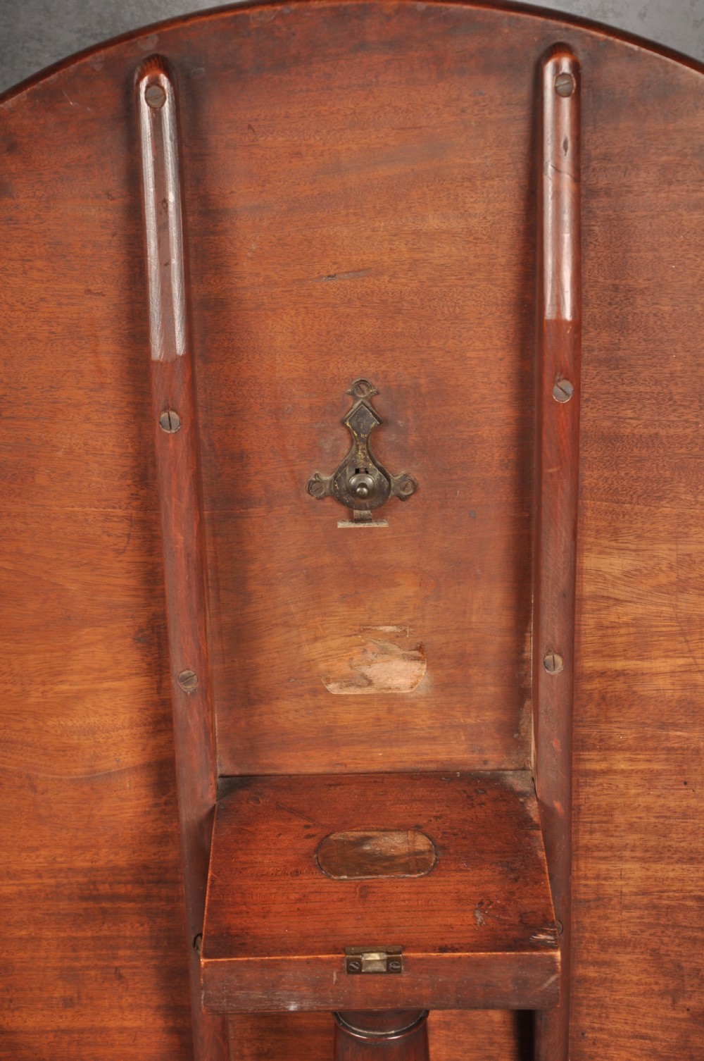 An 18th-century mahogany tripod table with a circular top supported by a turned central stem and three splayed cabriole legs with pad feet. View VI