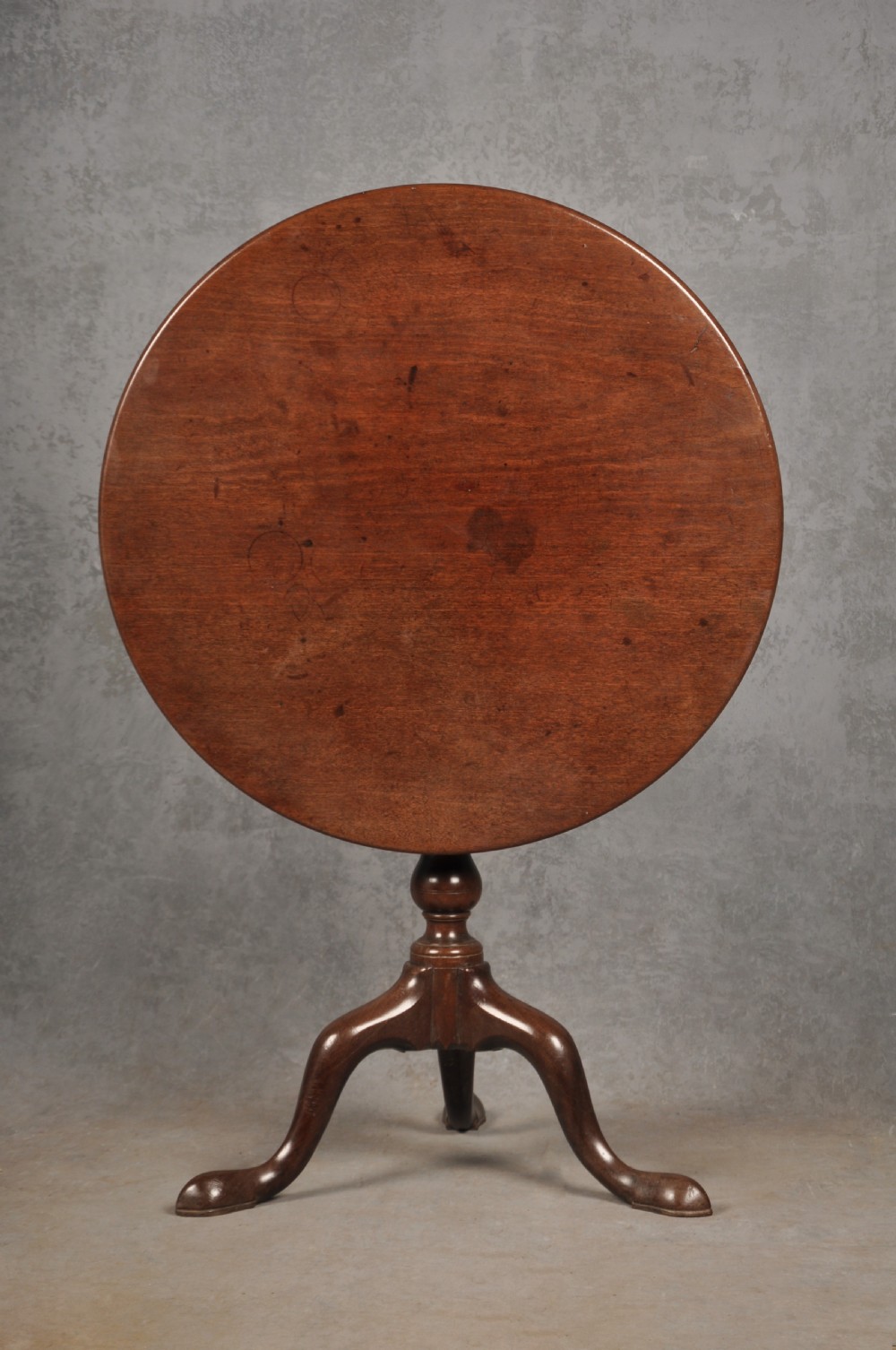 An 18th-century mahogany tripod table featuring a circular top, a central turned baluster pedestal, and three cabriole legs terminating in pad feet. View II