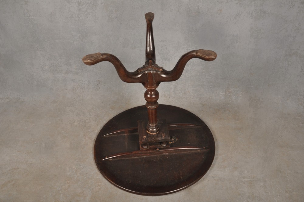 An 18th-century mahogany tripod table featuring a circular top, a central turned baluster pedestal, and three cabriole legs terminating in pad feet. View XI