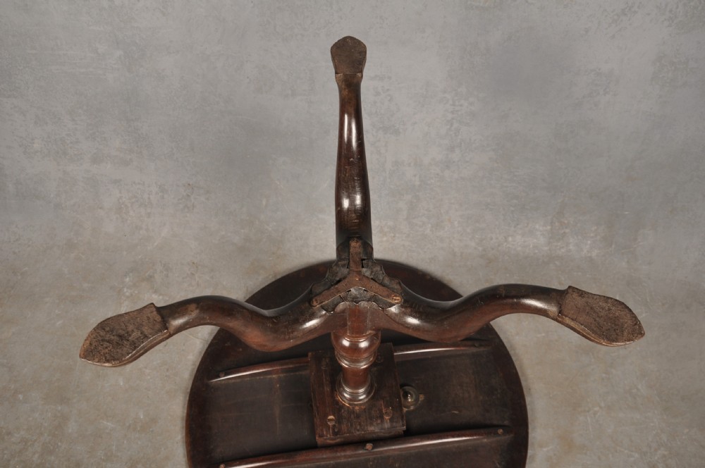 An 18th-century mahogany tripod table featuring a circular top, a central turned baluster pedestal, and three cabriole legs terminating in pad feet. View XII