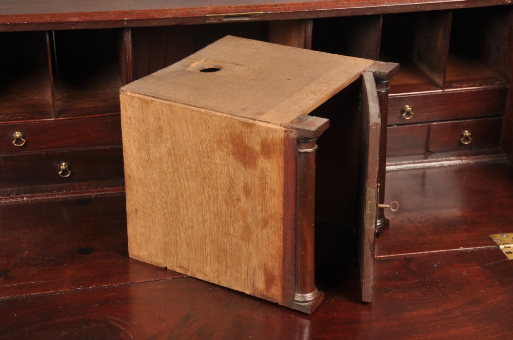 An eighteenth-century mahogany slant-front writing bureau featuring four graduated drawers with brass swan-neck handles and bracket feet. View VI