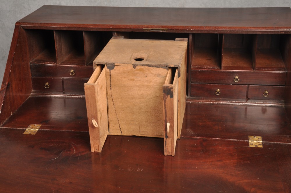 An eighteenth-century mahogany slant-front writing bureau featuring four graduated drawers with brass swan-neck handles and bracket feet. View VII