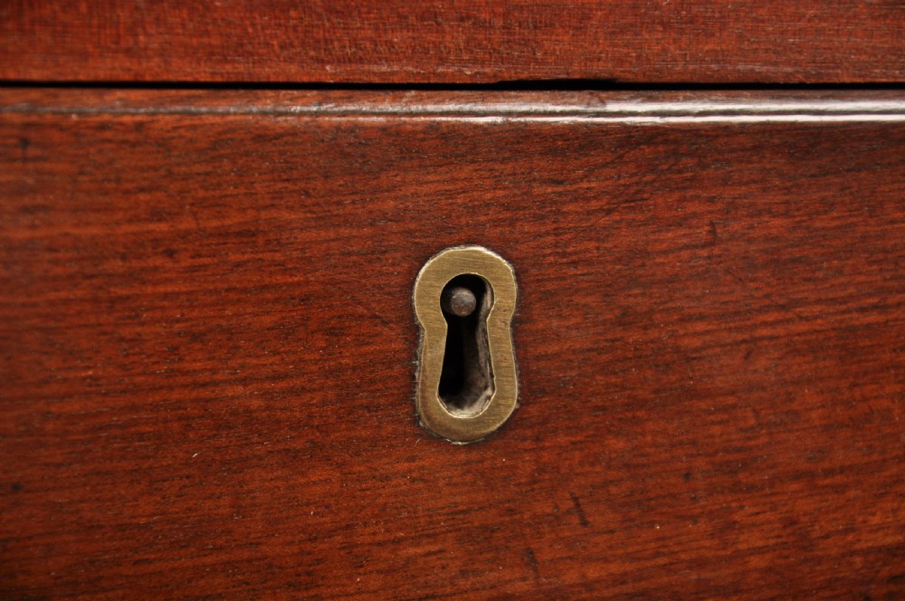An eighteenth-century mahogany slant-front writing bureau featuring four graduated drawers with brass swan-neck handles and bracket feet. View XII