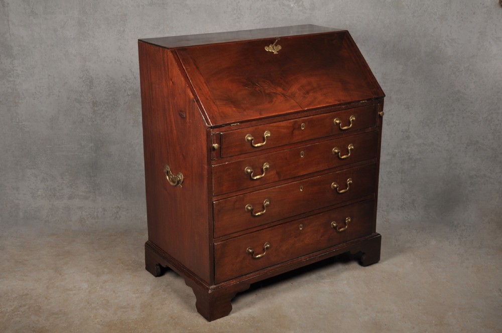 An eighteenth-century mahogany slant-front writing bureau featuring four graduated drawers with brass swan-neck handles and bracket feet. View XVIII