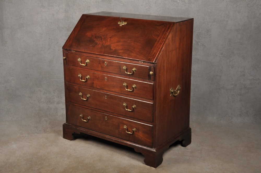 An eighteenth-century mahogany slant-front writing bureau featuring four graduated drawers with brass swan-neck handles and bracket feet. View XIX
