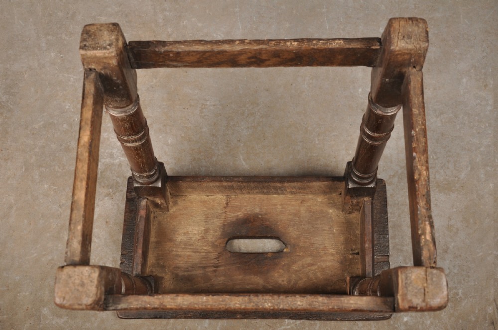 A 17th-century oak joint stool with turned legs, mortise-and-tenon peg construction, and lower perimeter stretchers. View VII