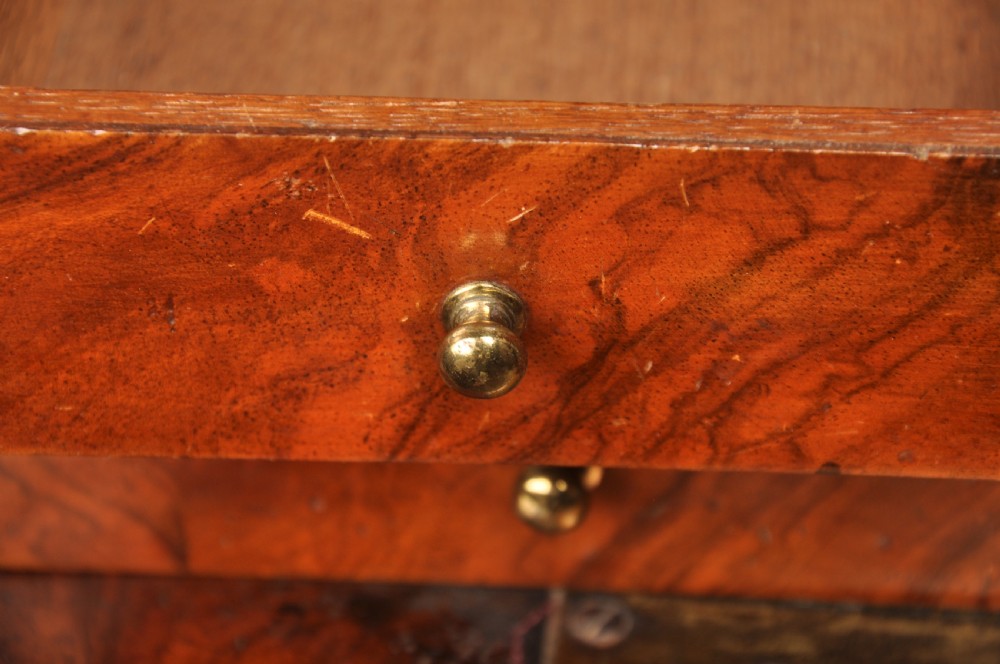 An early eighteenth-century burr walnut secretaire cabinet featuring double upper doors and a lower chest of drawers with brass handles. View XXII