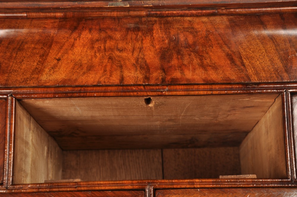 An early eighteenth-century burr walnut secretaire cabinet featuring double upper doors and a lower chest of drawers with brass handles. View XXIX