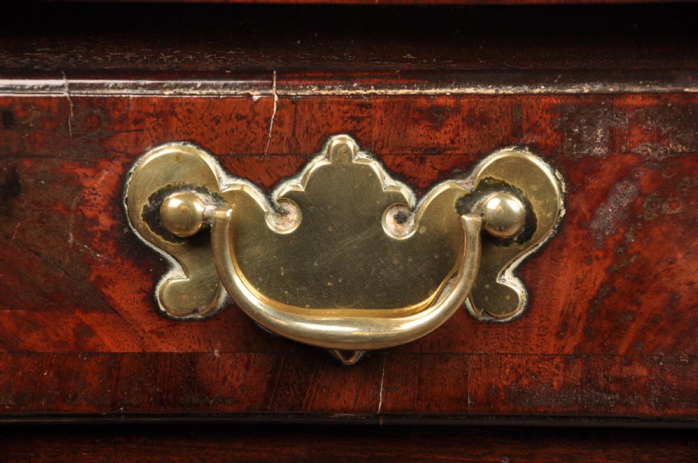An 18th-century George II mahogany lowboy with three drawers, brass handles, a central arch apron, and four cabriole legs ending in pad feet. View V
