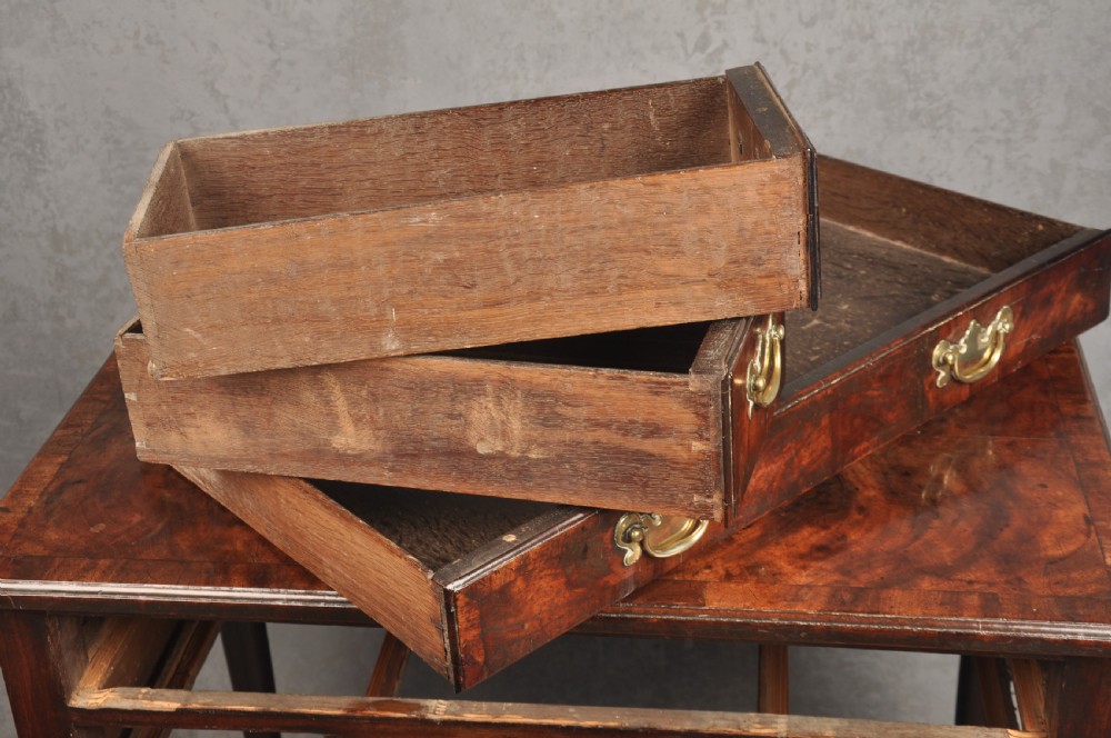 An 18th-century George II mahogany lowboy with three drawers, brass handles, a central arch apron, and four cabriole legs ending in pad feet. View VI
