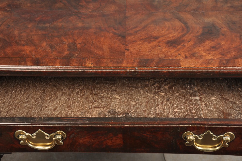 An 18th-century George II mahogany lowboy with three drawers, brass handles, a central arch apron, and four cabriole legs ending in pad feet. View VIII