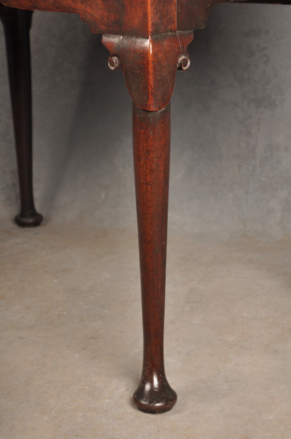 An 18th-century George II mahogany lowboy with three drawers, brass handles, a central arch apron, and four cabriole legs ending in pad feet. View XII