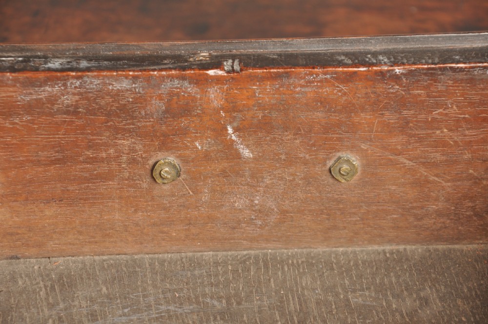 An early 18th-century walnut lowboy side table featuring three drawers with brass handles, a shaped apron, and four cabriole legs. View V