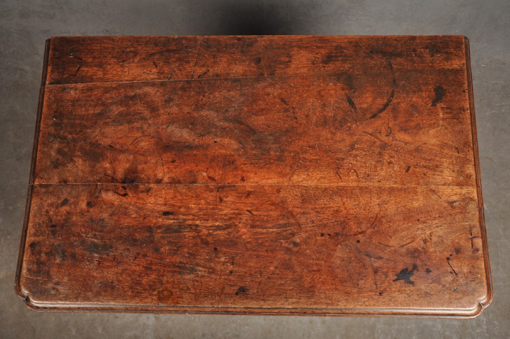 An early 18th-century walnut lowboy side table featuring three drawers with brass handles, a shaped apron, and four cabriole legs. View IX