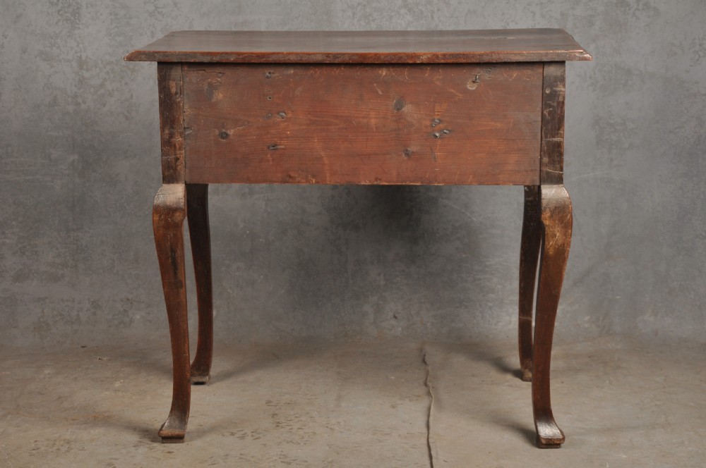 An early 18th-century walnut lowboy side table featuring three drawers with brass handles, a shaped apron, and four cabriole legs. View XI