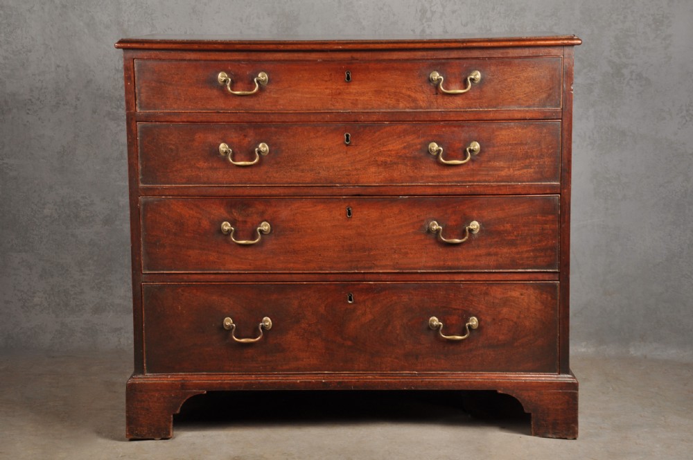 An 18th-century Georgian mahogany chest featuring four graduated drawers with brass swan-neck handles and bracket feet.
