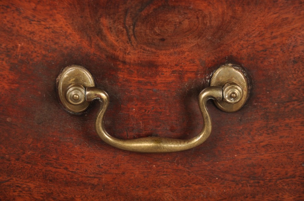 An 18th-century Georgian mahogany chest featuring four graduated drawers with brass swan-neck handles and bracket feet. View II