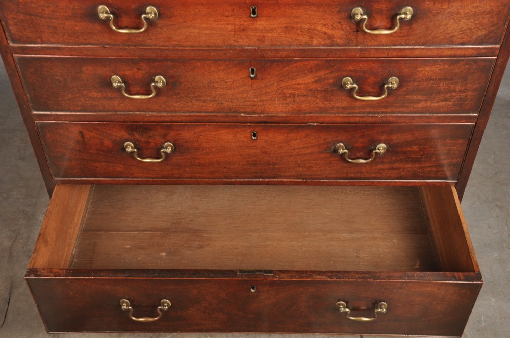 An 18th-century Georgian mahogany chest featuring four graduated drawers with brass swan-neck handles and bracket feet. View V