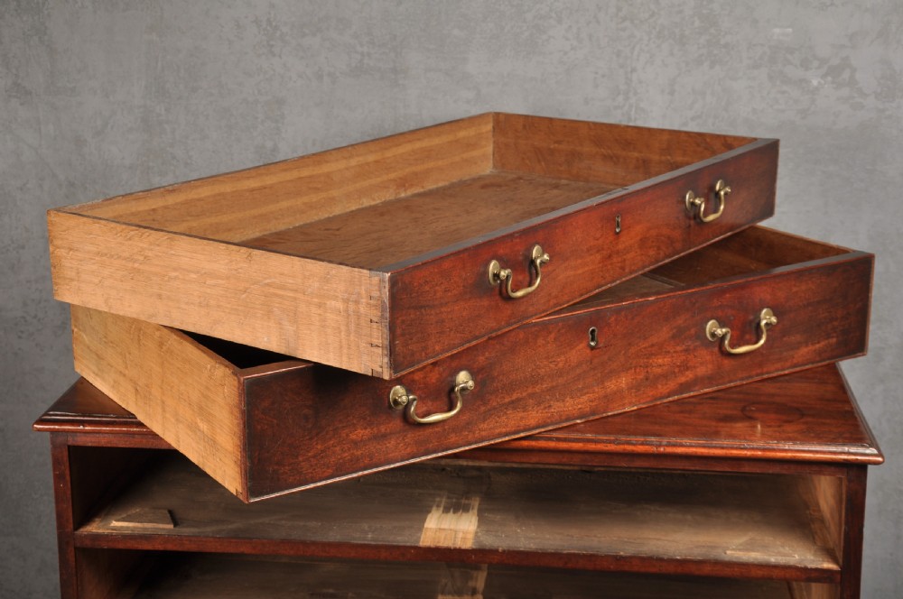 An 18th-century Georgian mahogany chest featuring four graduated drawers with brass swan-neck handles and bracket feet. View VII