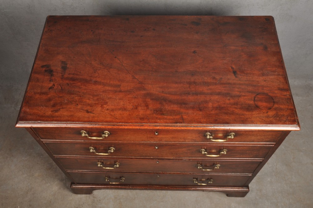 An 18th-century Georgian mahogany chest featuring four graduated drawers with brass swan-neck handles and bracket feet. View XI