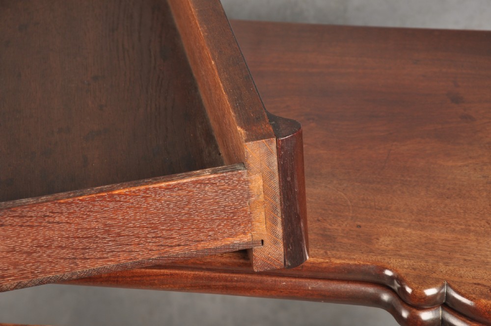 An 18th-century Georgian mahogany fold-over tea table featuring cabriole legs terminating in hand-carved ball and claw feet. View V