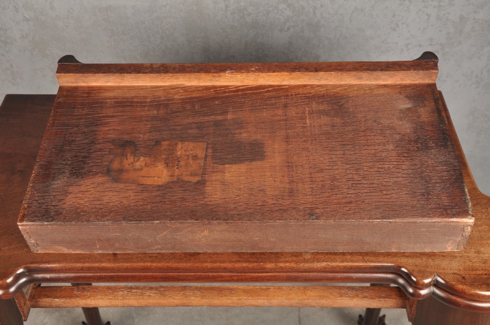 An 18th-century Georgian mahogany fold-over tea table featuring cabriole legs terminating in hand-carved ball and claw feet. View VI