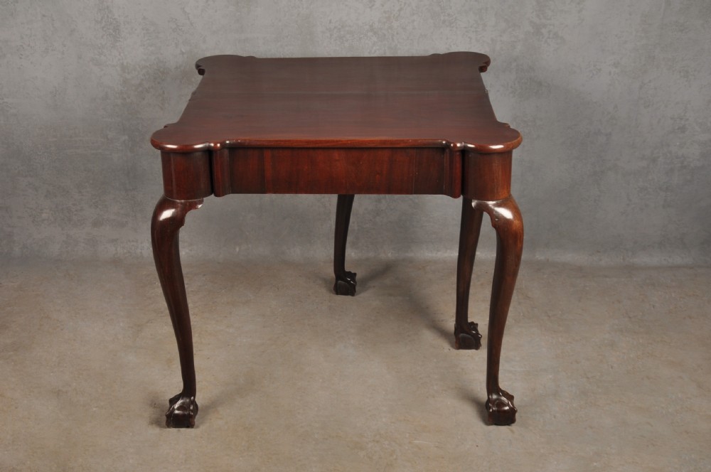An 18th-century Georgian mahogany fold-over tea table featuring cabriole legs terminating in hand-carved ball and claw feet. View XI