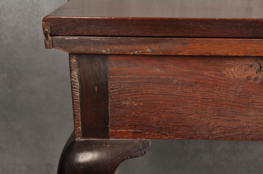 An 18th-century Georgian mahogany fold-over tea table featuring cabriole legs terminating in hand-carved ball and claw feet. View XIV