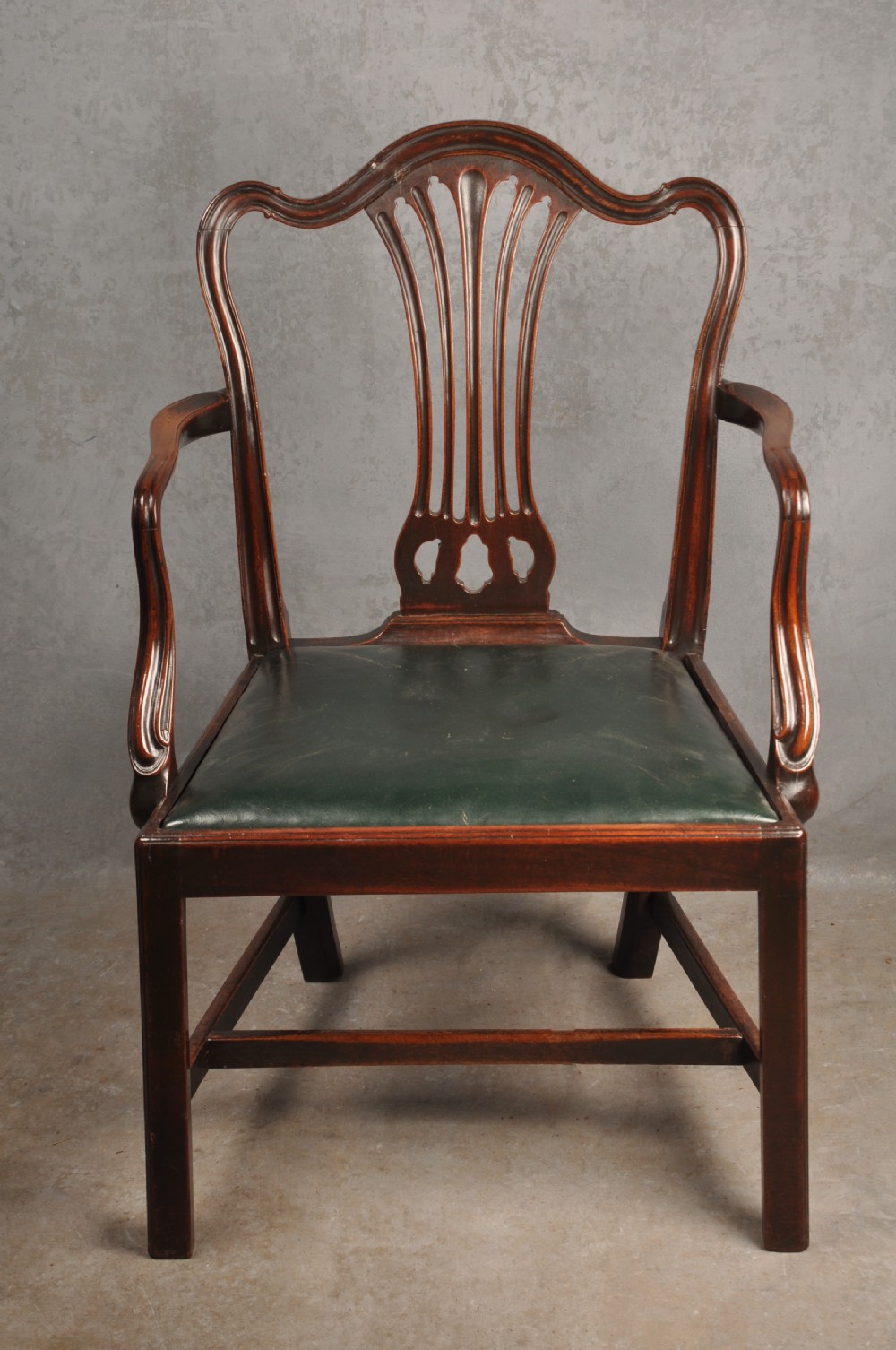 A set of eight 18th-century mahogany Hepplewhite dining chairs featuring pierced splat backrests, serpentine crest rails, square legs with stretchers, and dark green leather drop-in seats. View II