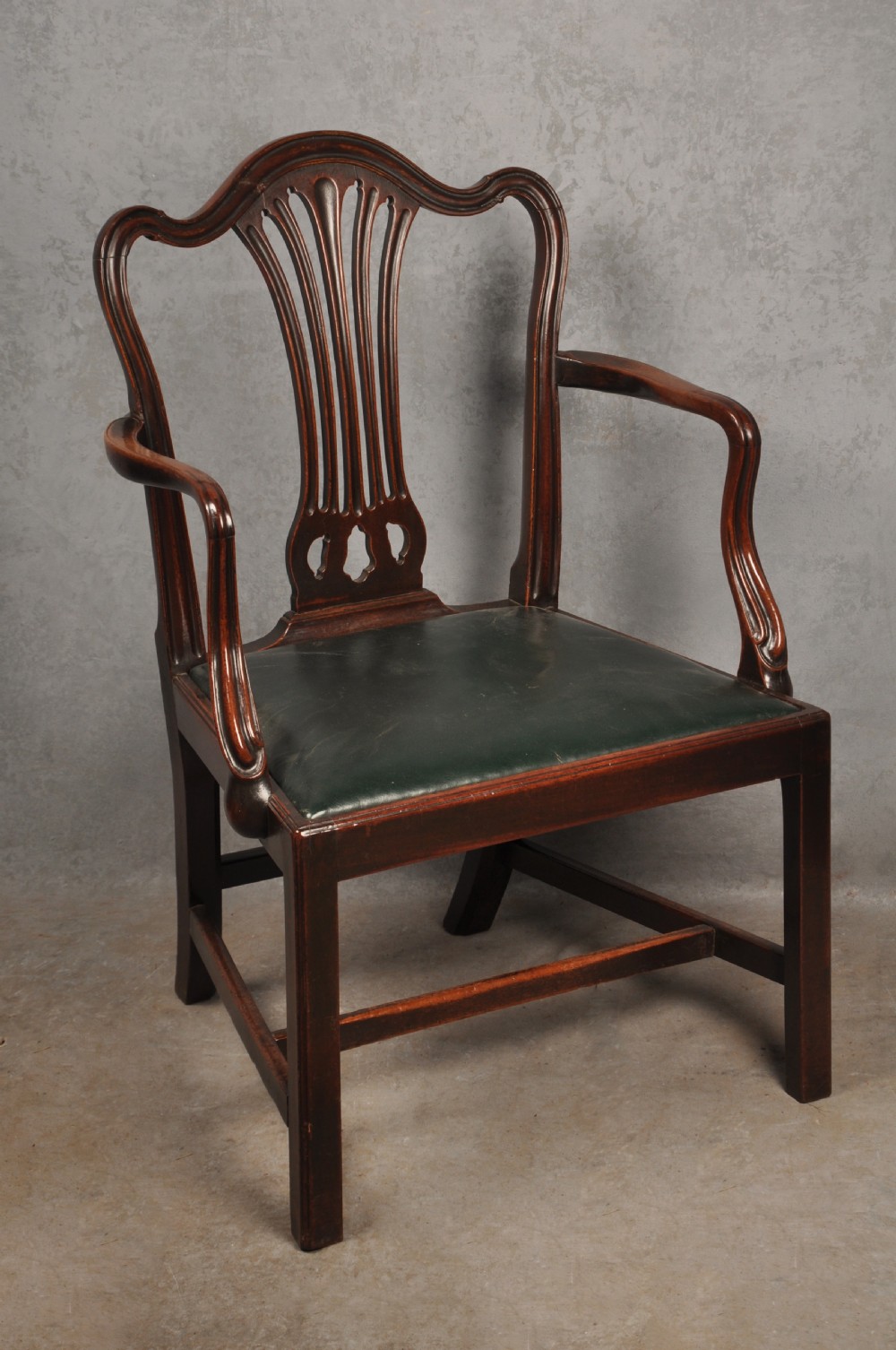 A set of eight 18th-century mahogany Hepplewhite dining chairs featuring pierced splat backrests, serpentine crest rails, square legs with stretchers, and dark green leather drop-in seats. View III