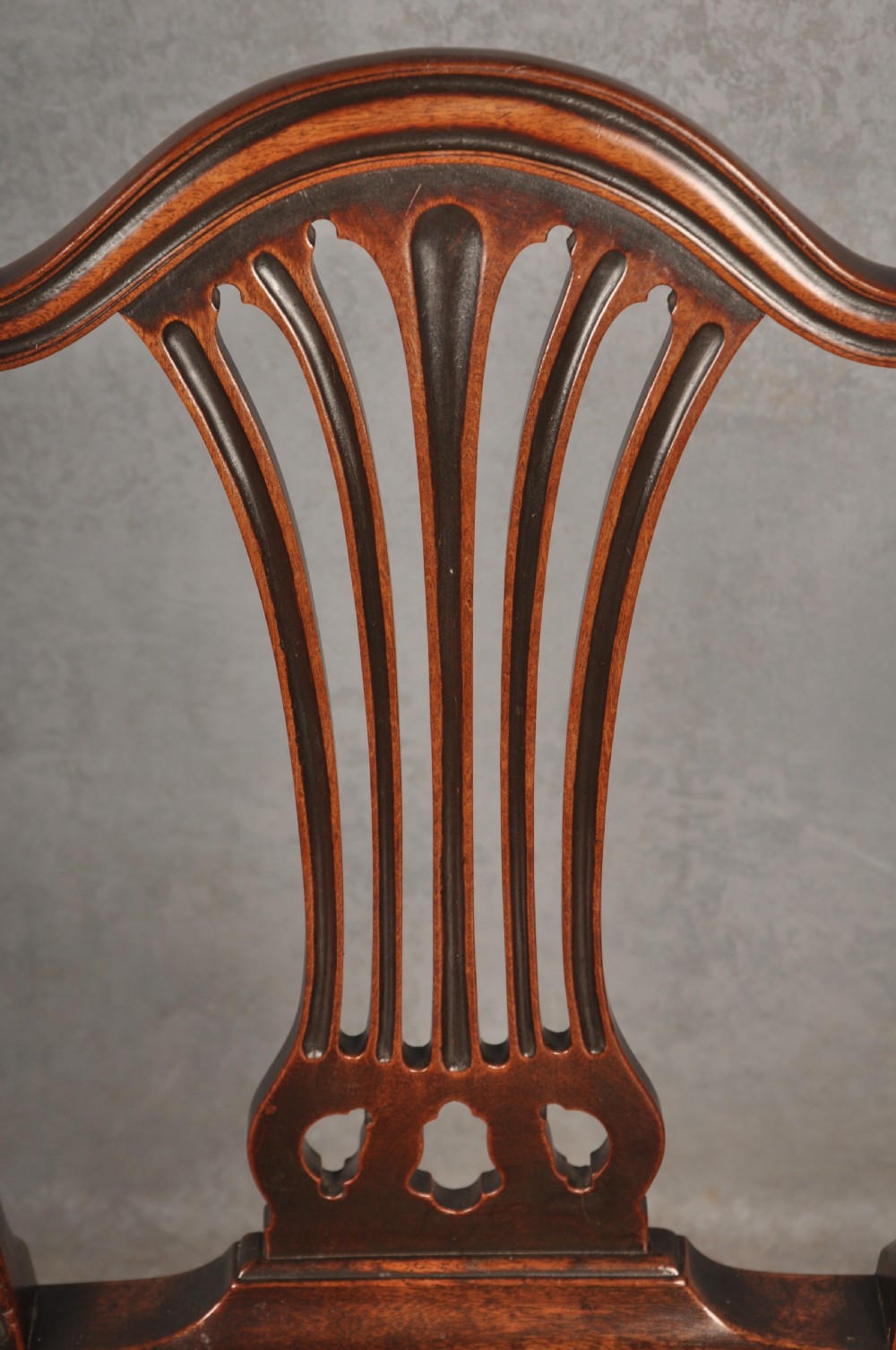 A set of eight 18th-century mahogany Hepplewhite dining chairs featuring pierced splat backrests, serpentine crest rails, square legs with stretchers, and dark green leather drop-in seats. View XI