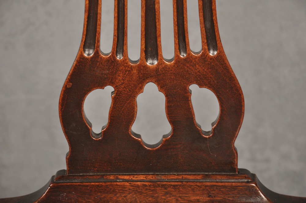 A set of eight 18th-century mahogany Hepplewhite dining chairs featuring pierced splat backrests, serpentine crest rails, square legs with stretchers, and dark green leather drop-in seats. View XII