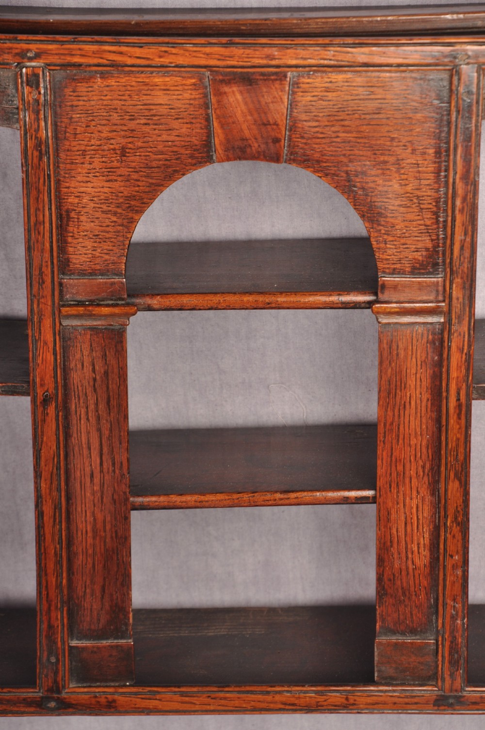 An eighteenth-century dark oak delft rack featuring open shelves, a central arched niche, and a moulded top cornice. View VIII