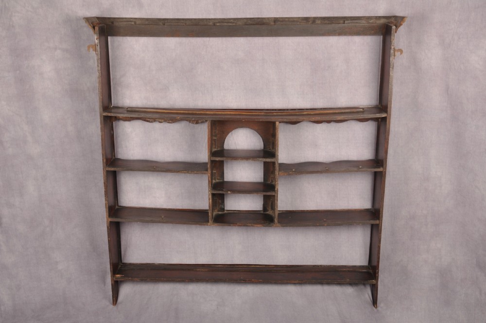 An eighteenth-century dark oak delft rack featuring open shelves, a central arched niche, and a moulded top cornice. View XI