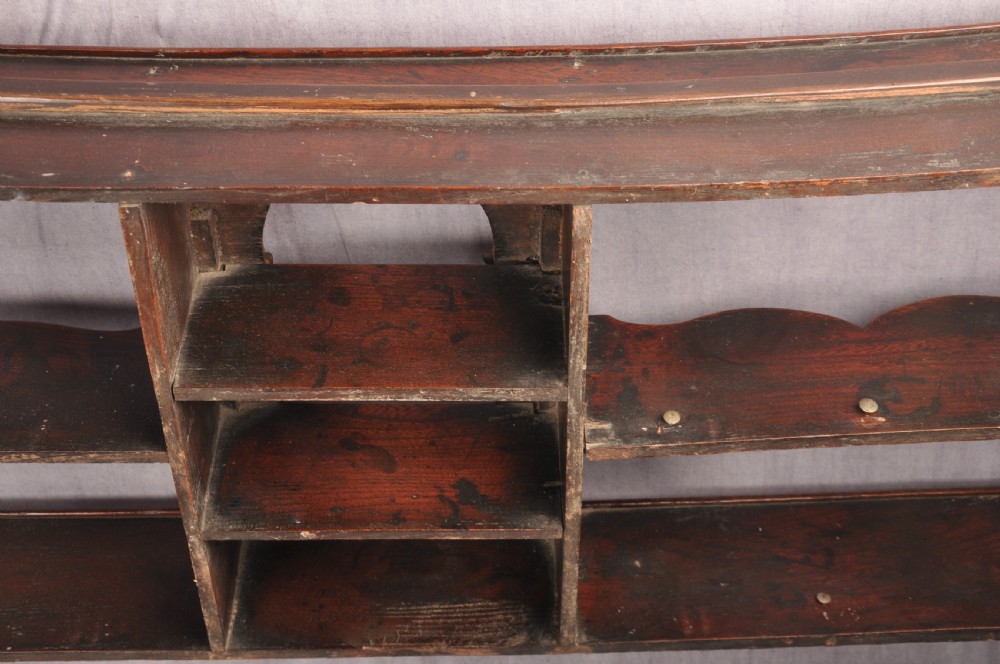 An eighteenth-century dark oak delft rack featuring open shelves, a central arched niche, and a moulded top cornice. View XII