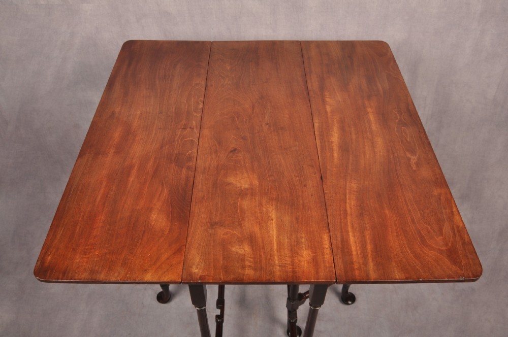 An eighteenth-century mahogany drop-leaf spider table featuring slender turned legs, cross stretchers, and pad feet. View II