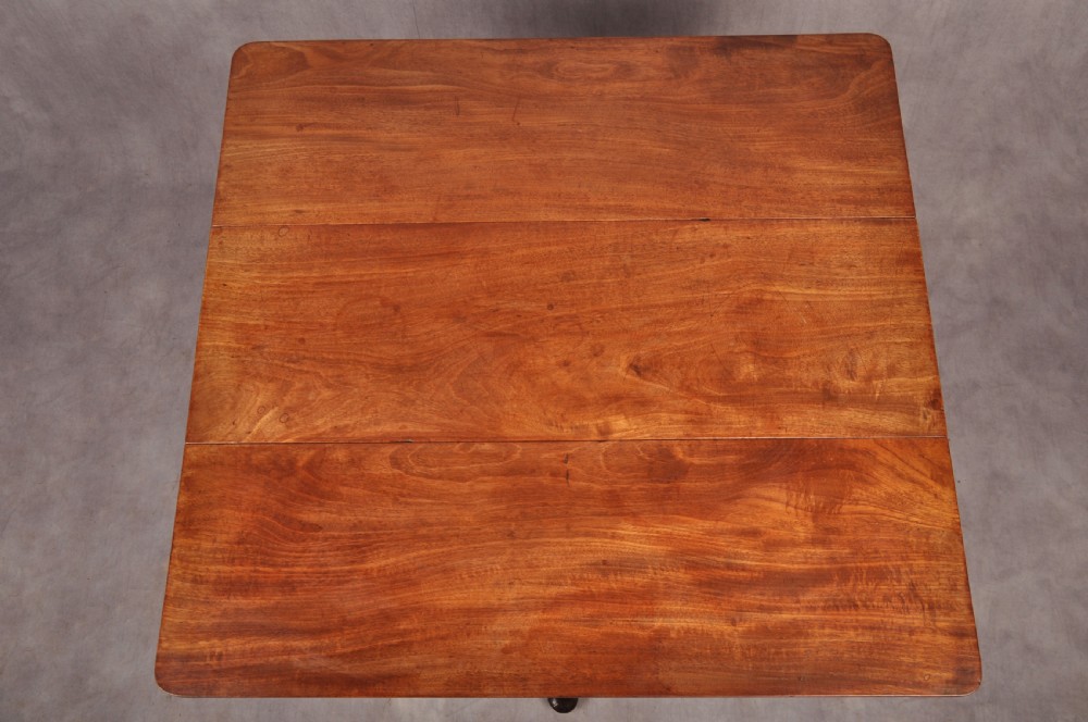 An eighteenth-century mahogany drop-leaf spider table featuring slender turned legs, cross stretchers, and pad feet. View IV