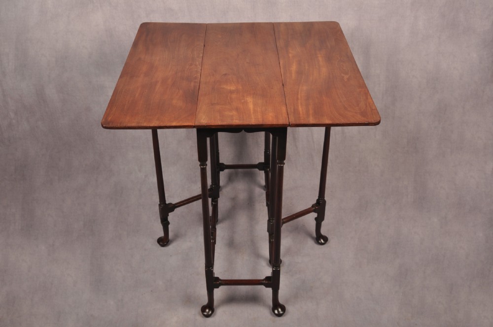 An eighteenth-century mahogany drop-leaf spider table featuring slender turned legs, cross stretchers, and pad feet. View V